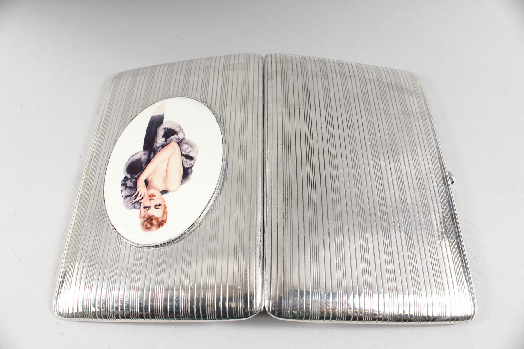 AN ENGINE TURNED SILVER CIGARETTE CASE, with an oval of a model with a fur coat. - Image 2 of 4