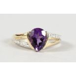 A 9CT GOLD PEAR SHAPED AMETHYST AND DIAMOND RING.