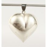 A LARGE SILVER HEART SHAPED PENDANT.