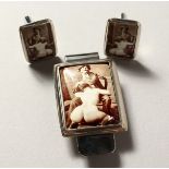 A SILVER ENAMEL EROTIC MONEY CLIP AND CUFFLINKS.