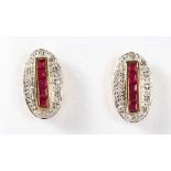 A PAIR OF 9K GOLD CALIBRE CUT RUBIES AND DECO STYLE EARRINGS.