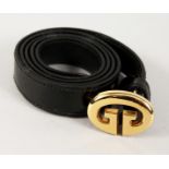 A GUCCI BLACK LEATHER BELT with gilt GUCCI.