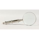 A MAGNIFYING GLASS with chrome handle.