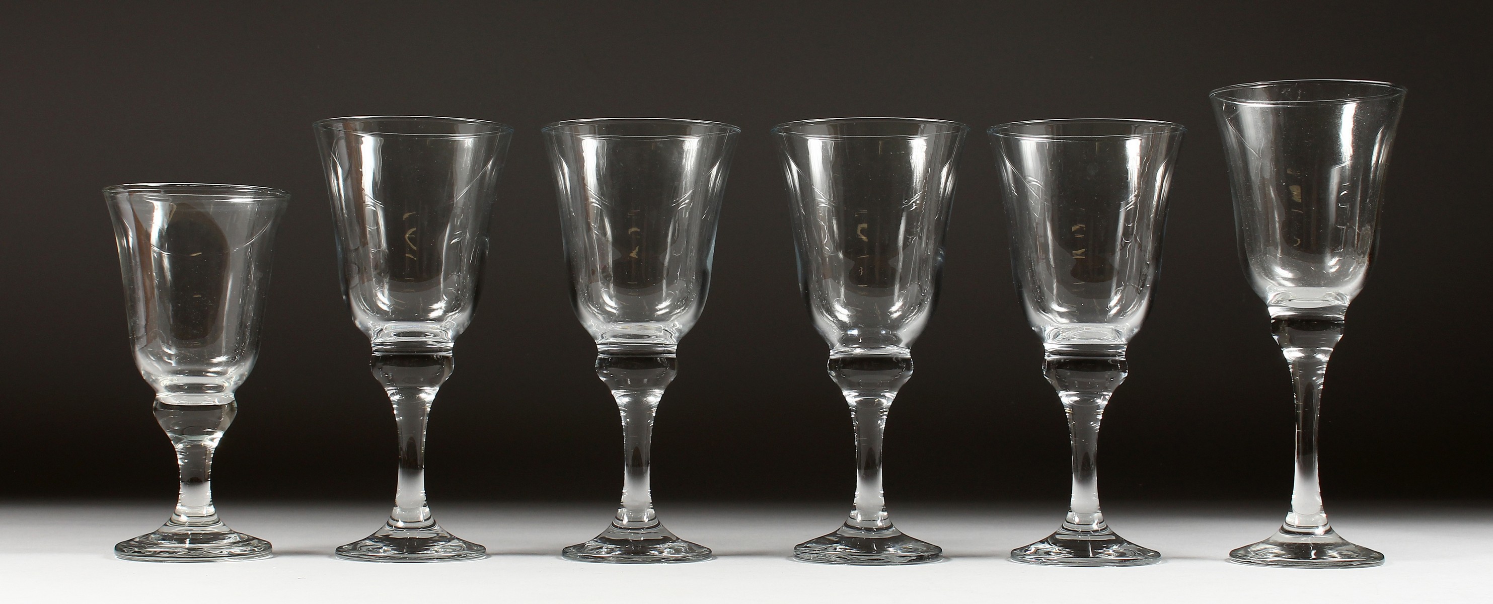 SIX HEAVY WINE GLASSES in three sizes.