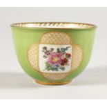 A MINIATURE MEISSEN CIRCULAR GREEN BOWL with panels of flowers. Cross swords mark. 2.25ins