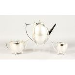 A SILVER PLATE THREE-PIECE ART DECO DESIGN TEA SET.