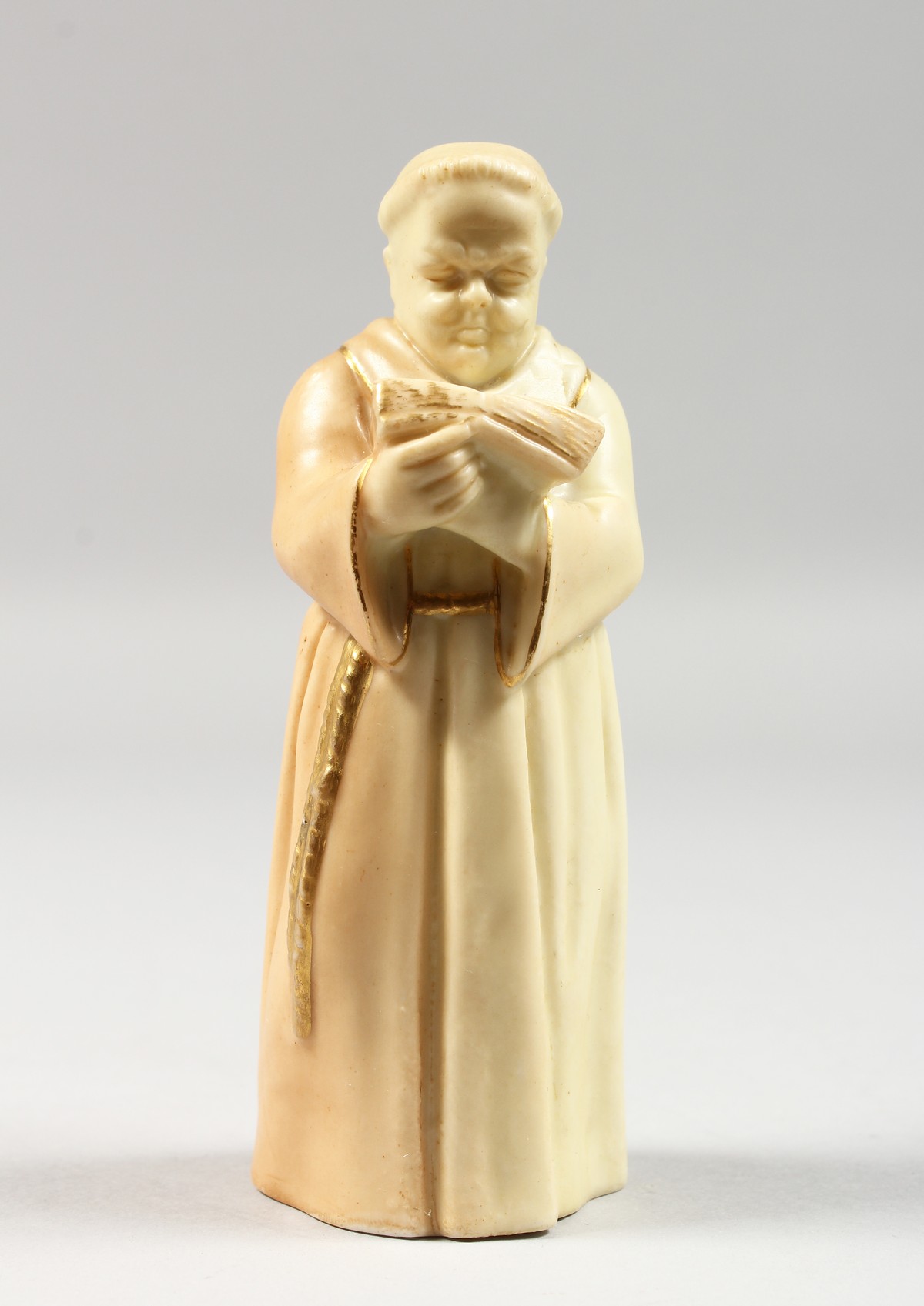 A ROYAL WORCESTER CANDLE SNUFFER OF A MONK in uncommon blush ivory, date code 1905.