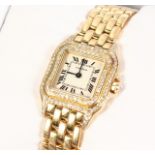 A SUPERB 18CT GOLD LADIES CARTIER WRISTWATCH AND BRACELET with two rows of diamonds, No. 107000N