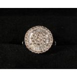 A VERY GOOD 18K WHITE GOLD DIAMOND BAGUETTE ROUND RING.