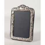 A PHOTOGRAPH FRAME with repousse border. 7ins x 4.5ins.