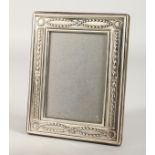AN UPRIGHT PHOTOGRAPH FRAME with laurel wreath and garlands. 6.75ins x 5.5ins.