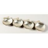 A SET OF FOUR SILVER SHELL SALTS, STERLING MEXICO SILVER.