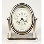 A GOOD ASPREY OF LONDON OVAL CHROME CLOCK with engine turned face. 5ins high.