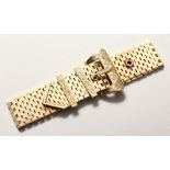 A LONG 9CT GOLD BRACELET with buckle.
