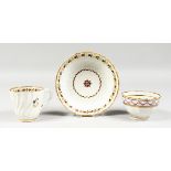 A LATE 18TH CENTURY NEW HALL TYPE FACETED COFFEE CUP, TEA BOWL AND SAUCER painted with puce festoons