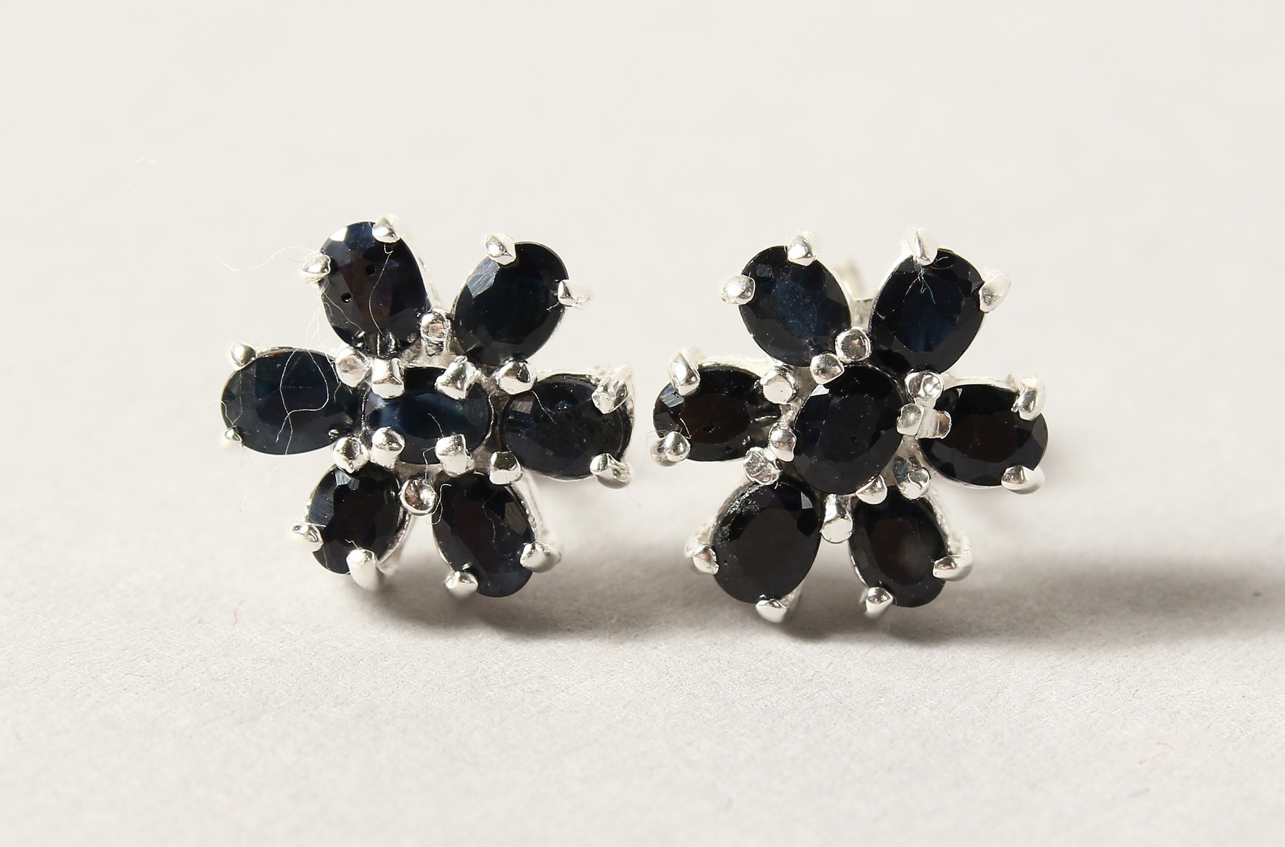 A PAIR OF SILVER AND SAPPHIRE EARRINGS.