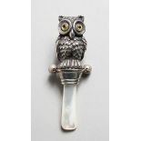 A SILVER NOVELTY OWL RATTLE.