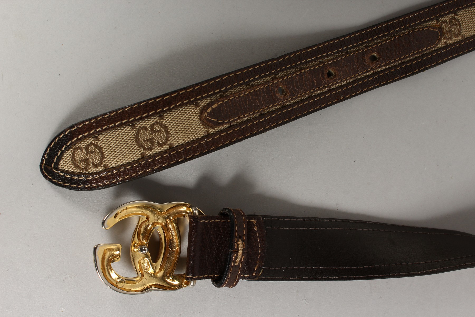 A BROWN LEATHER AND FABRIC GUCCI BELT with gilt GG. - Image 3 of 4