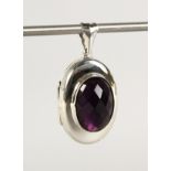 A SILVER AND AMETHYST LOCKET.