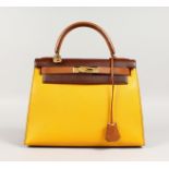 A GOOD HERMES TWO COLOUR LEATHER KELLY BAG, brown and yellow with brass lock. No. 004. 11ins long