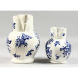 A GRADUATED PAIR OF DECORATIVE ENGLISH PORCELAIN MASK JUGS printed with fir cones and roses in