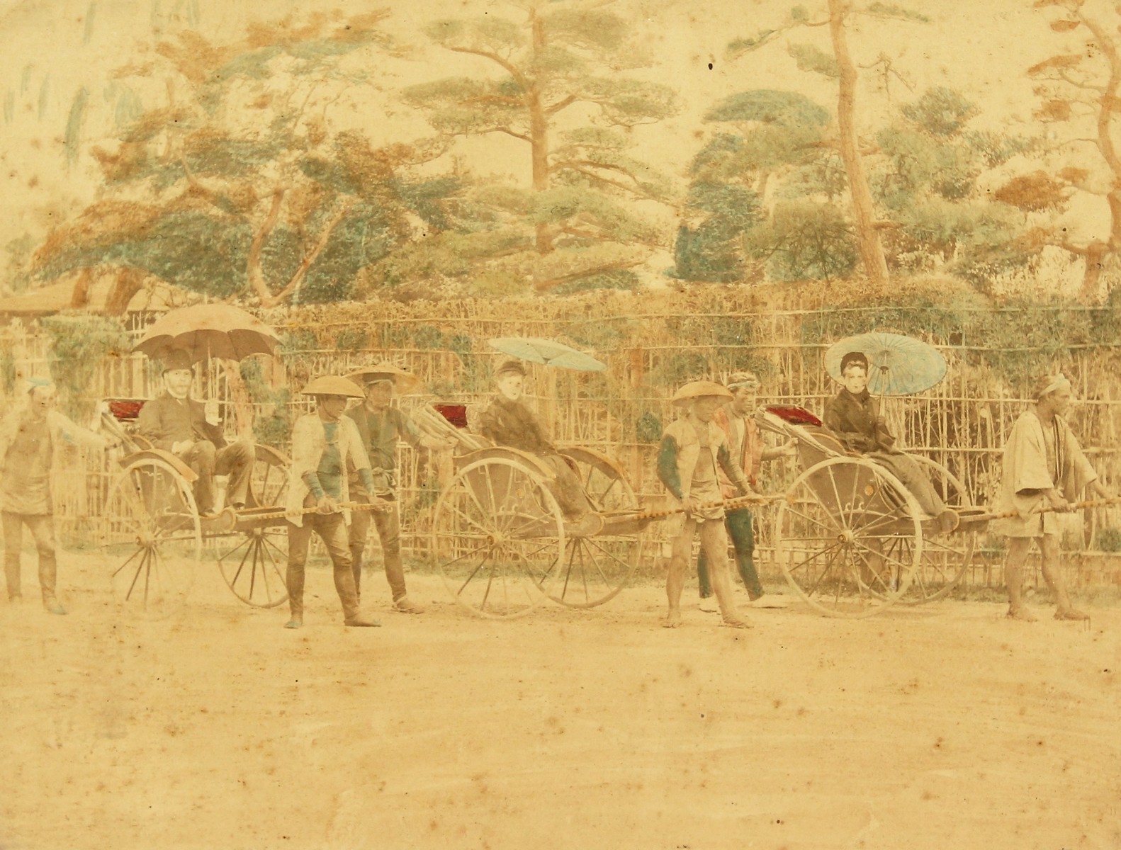 Japanese (c. 1880-1890), A colonial scene of figures on rickshaws, hand-tinted photograph, 8" x