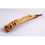 A 19TH CENTURY CARVED RHINOCEROS HORN STICK HANDLE, carved with a four legged animal amongst