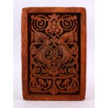 A CARVED WOODEN ISLAMIC / EGYPTIAN PLAQUE - carved with formal motif, 31cm x 22cm.