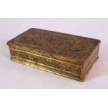 A PERSIAN BRASS ENGRAVED LIDDED BOX, carved with birds amongst flora and floral motif, 16cm x 9cm