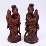 A PAIR OF CHINESE 19TH CENTURY CARVED WOODEN FIGURES, 22cm high