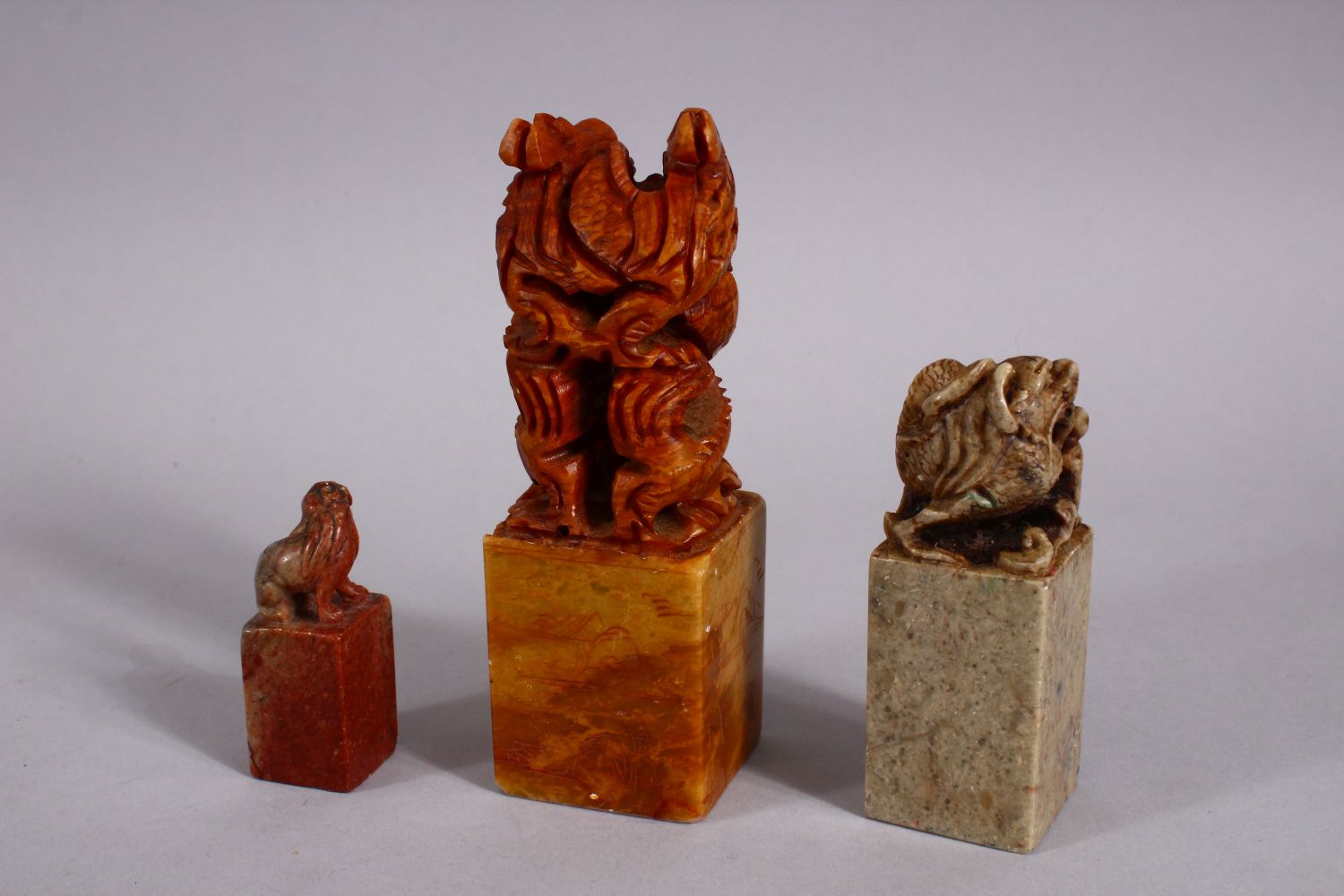 THREE CHINESE CARVED SOAPSTONE SEALS, each carved with dragons and lion dogs, two bases carved - Image 3 of 4