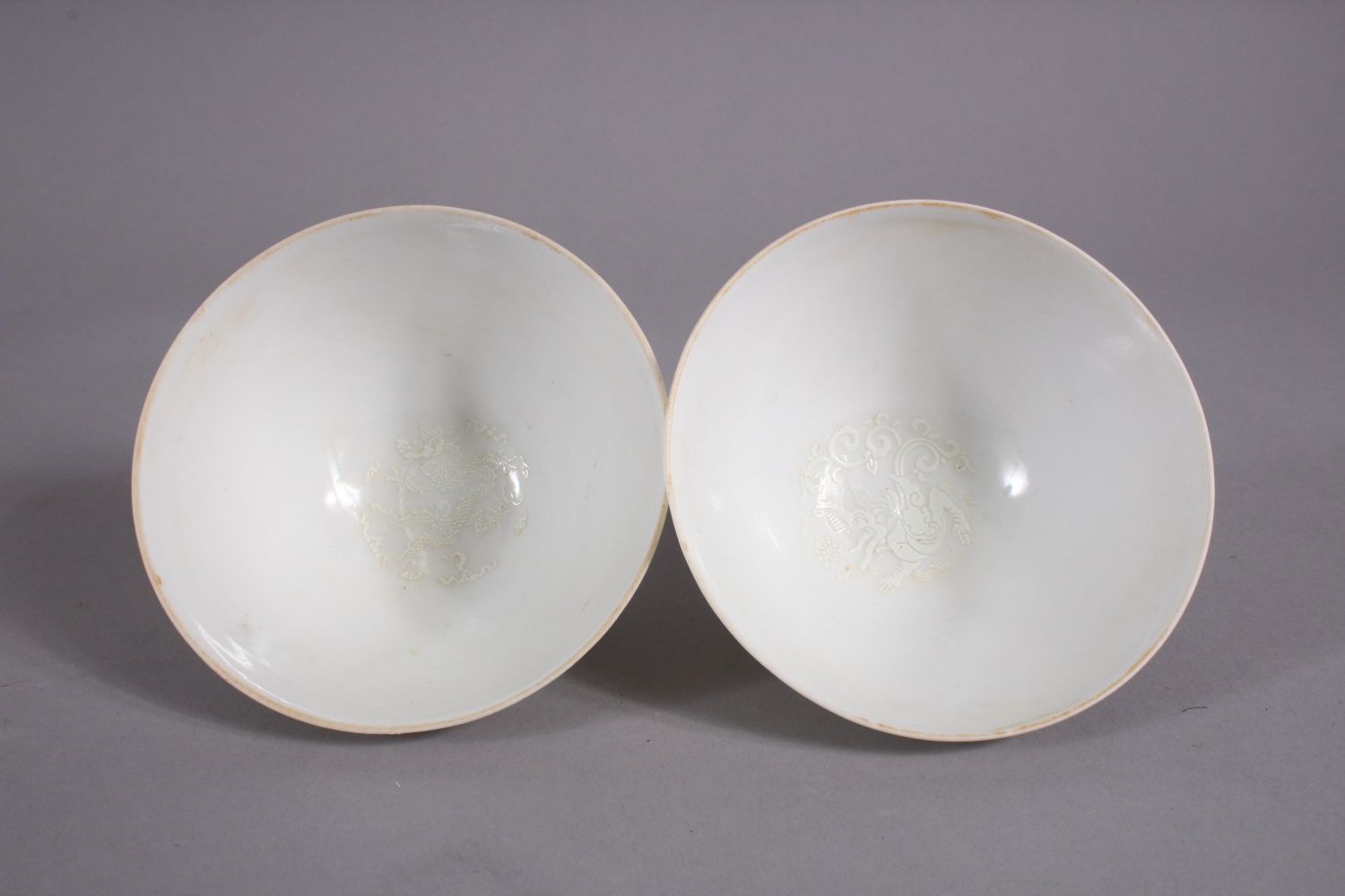 A PAIR OF CHINESE MING STYLE MONOCHROME CARVED PORCELAIN TEA BOWLS, with carved decorations of - Image 2 of 8