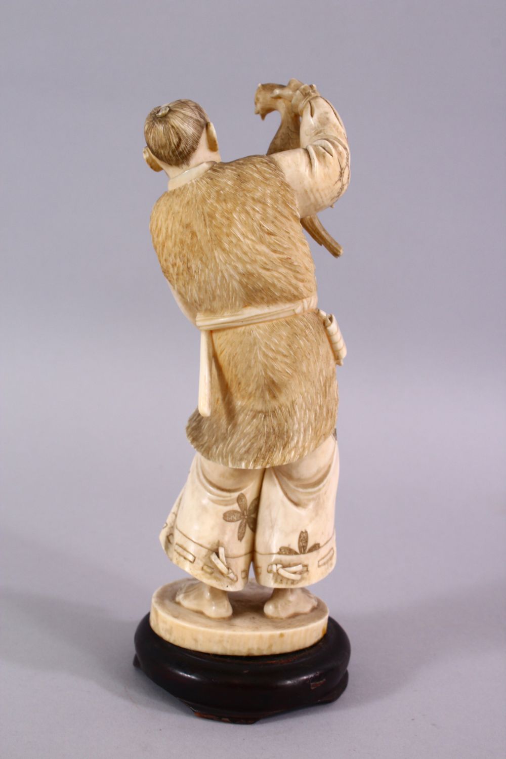 A FINE JAPANESE MEIJI PERIOD CARVED IVORY OKIMONO OF A HUNTSMAN, stood holding his catch with his - Image 3 of 6