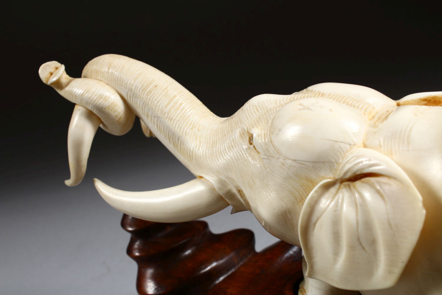 A 19TH CENTURY CHINESE CARVED IVORY FIGURE OF AN ELEPHANT, the elephant holding on to the horn of - Image 6 of 9