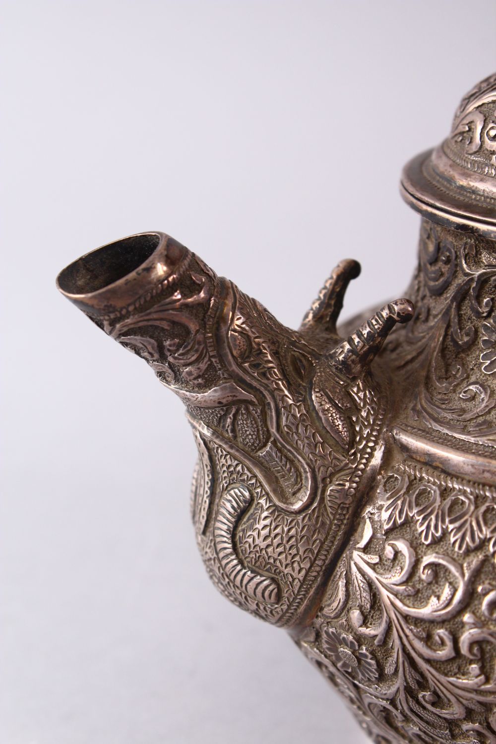 A GOOD 19TH CENTURY TURKISH SOLID SILVER TEAPOT carved with formal foliage and a dog style handle, - Image 6 of 10