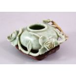 A CHINESE CARVED JADE FLORAL CARVED BRUSH WASH, on a fitted wooden base, 13 cm diameter,