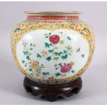 A CHINESE FAMILLE JAUNE PORCELAIN JAR & STAND, decorated with formal scrolling lotus, and panels