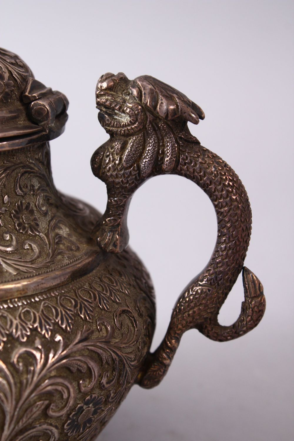 A GOOD 19TH CENTURY TURKISH SOLID SILVER TEAPOT carved with formal foliage and a dog style handle, - Image 5 of 10