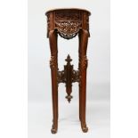 A LARGE 19TH / 20TH CENTURY ISLAMIC CARVED HARDWOOD CALLIGRAPHIC TABLE STAND, with carved frieze