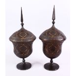 A FINE PAIR OF 19TH CENTURY PERSIAN QAJAR GOLD INLAID STEEL LIDDED URNS, with gold inlaid borders to