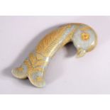 A 19TH / 20TH CENTURY CARVED JADE MUGHAL DAGGER HANDLE - in the form of a parrot, with gilded