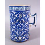 A LARGE OTTOMAN TURKISH POTTERY CUP, decorated with flora motif decoration, 20cm high x 18cm wide.