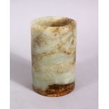 A SMALL CHINESE RUSSET CARVED JADE BRUSH WASHER, 9cm high x 6cm diameter.