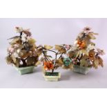 THREE CHINESE CARVED JADE MODEL TREES, each in carved pots with with carved flora, 28cm high &