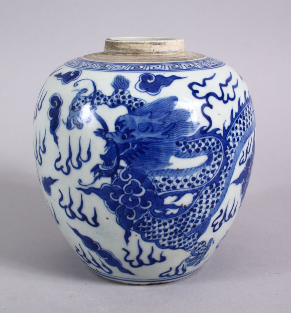 A CHINESE BLUE & WHITE PORCELAIN DRAGON GINGER JAR, decorated with a dragon amongst clouds 14cm