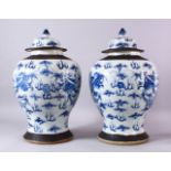 A PAIR OF 19TH CENTURY CHINESE BLUE & WHITE PORCELAIN VASES & COVERS, decorated with scenes of