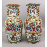 A PAIR OF 19TH CENTURY CHINESE CANTON FAMILLE ROSE PORCELAIN VASES, the white ground with panel