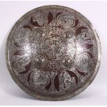 A 19TH / 20TH CENTURY INDIAN MUGHAL SILVER INLAID SHIELD, with figural decoration 46cm diameter.