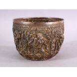 A FINE 19TH CENTURY BURMESE SILVER EMBOSSED BOWL, decorated with figures in panels, with animals and