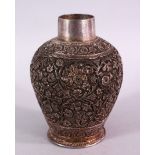 A 19TH CENTURY INDIAN SILVERED FLORAL VASE, carved with flora, the base signed, 13cm high.